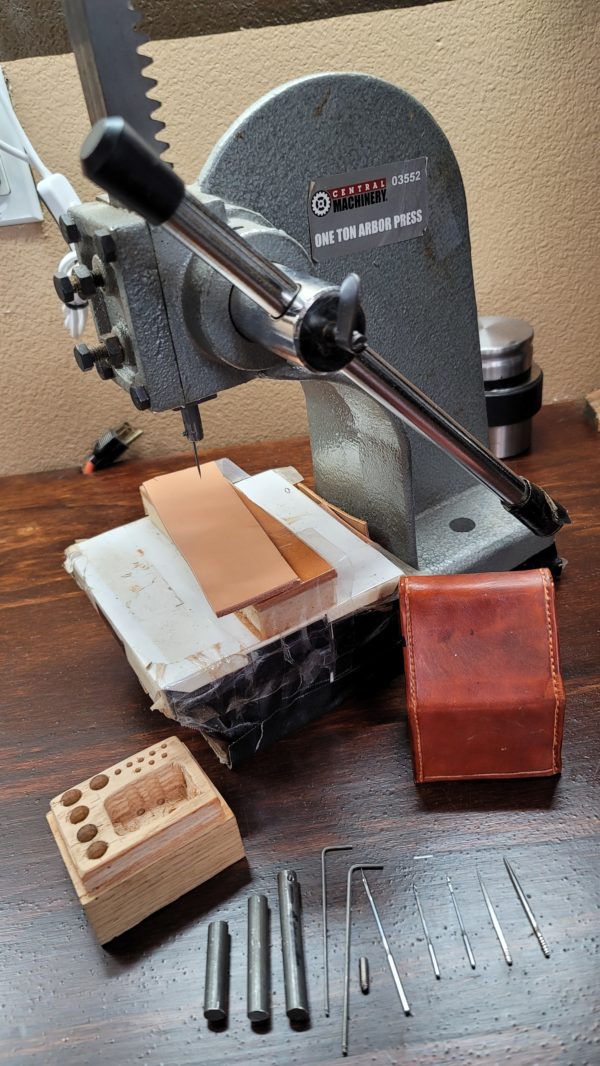 One of the most difficult and most critical parts of building a sheath or other stitched leather product is a stitch hole that is perfectly aligned on both sides of the product. This gets more difficult the thicker the piece is. This document shows how to modify and use an arbor press for perfect stitching holes.